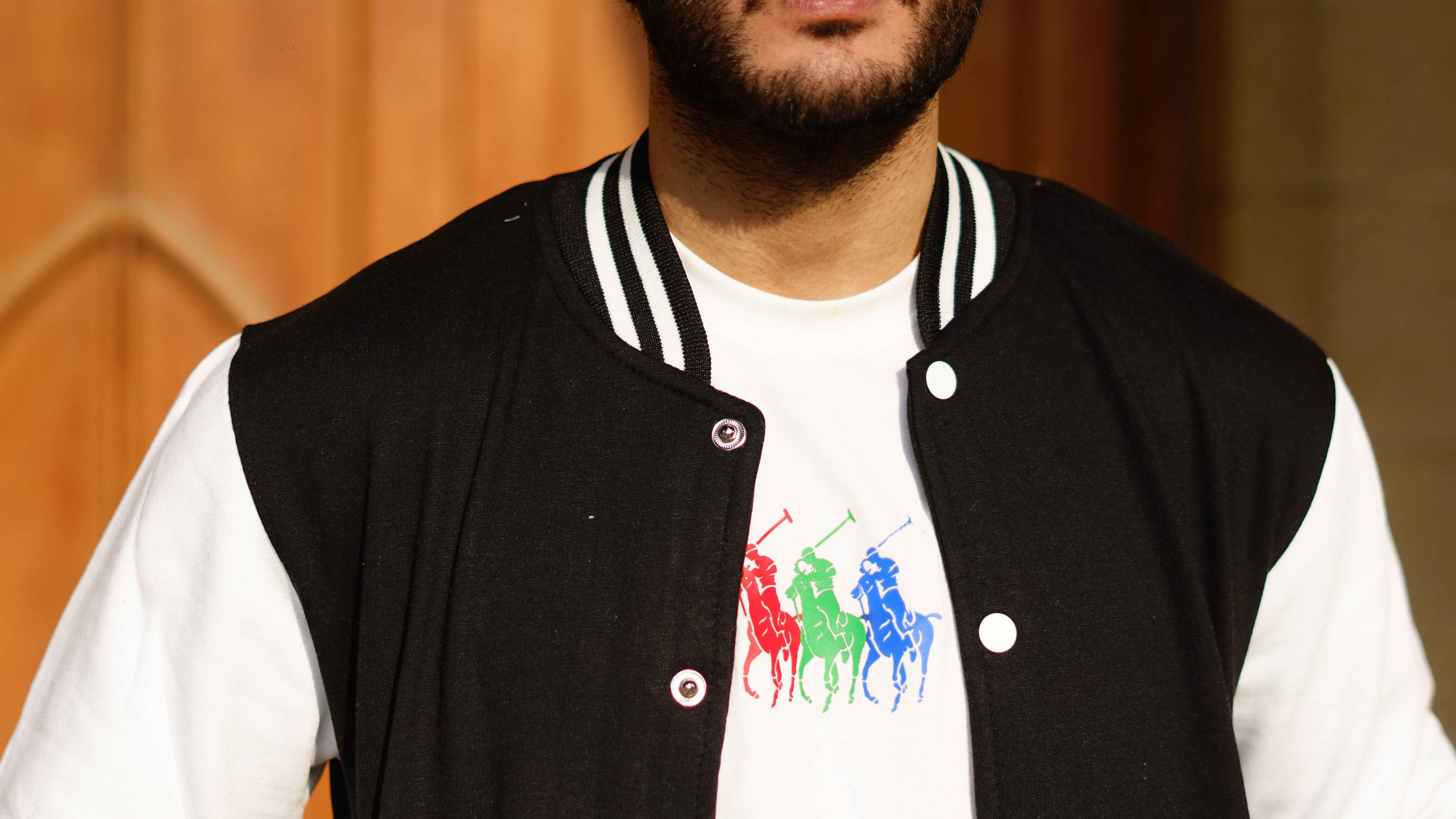 Man in black and white baseball jacket - Premium Baseball Jacket from The Divine Shop - Just Rs.2999! Shop now at The Divine Shop